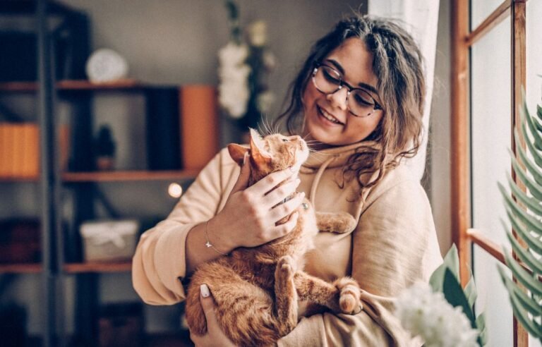 A calm cat resting closely with its owner at home, showing trust and emotional connection during illness – Can Cats Sense Illness in Humans